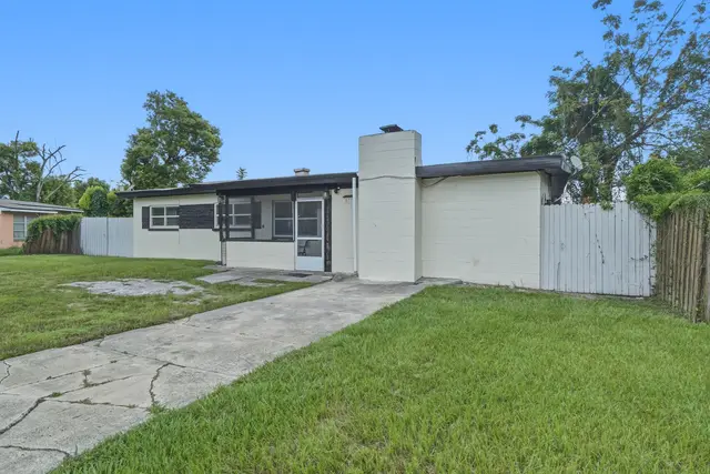 Private single-story home with fenced yard and easy driveway parking at The Clue House