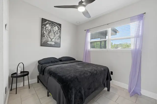 Bright minimalist bedroom with natural light and modern style at The Clue House