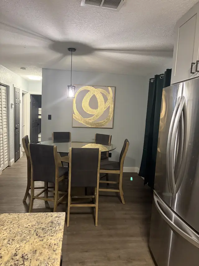 Modern dining nook by stainless kitchen, artful and open-concept at Downtown & Stadium Cozy Retreat