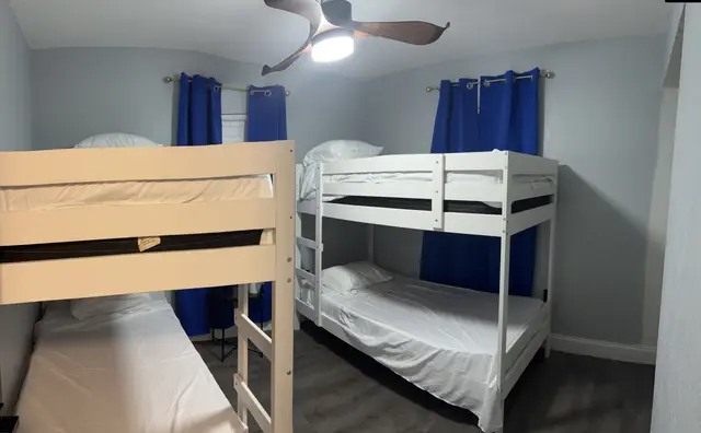 Family-friendly bunk room: 2 bunks, modern fan, blue blackout drapes at Downtown & Stadium Cozy Retreat