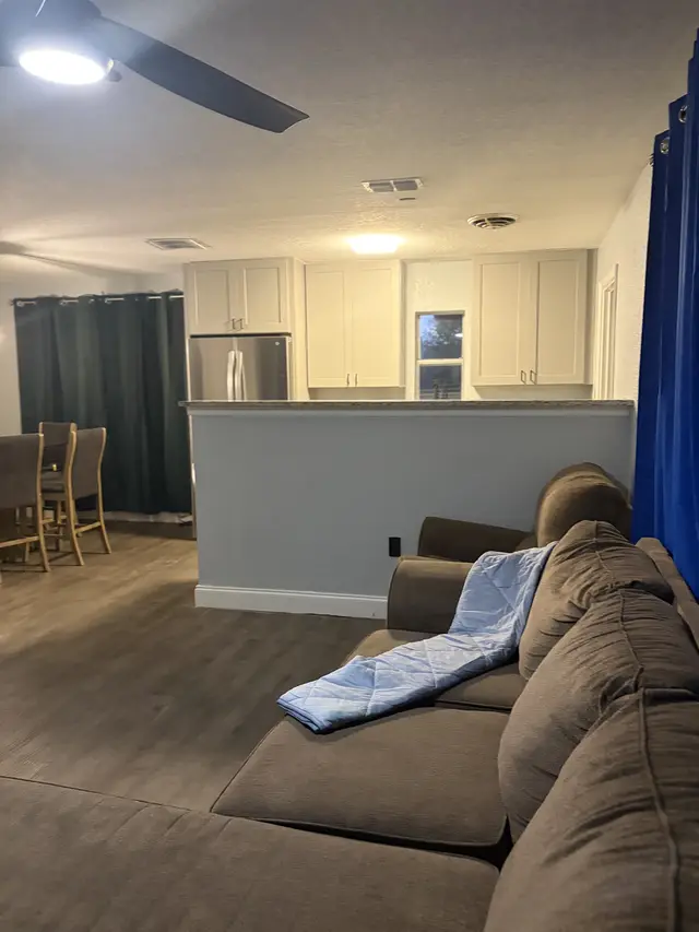 Cozy open-plan lounge + updated kitchen, dining nook, and big sectional. at Downtown & Stadium Cozy Retreat